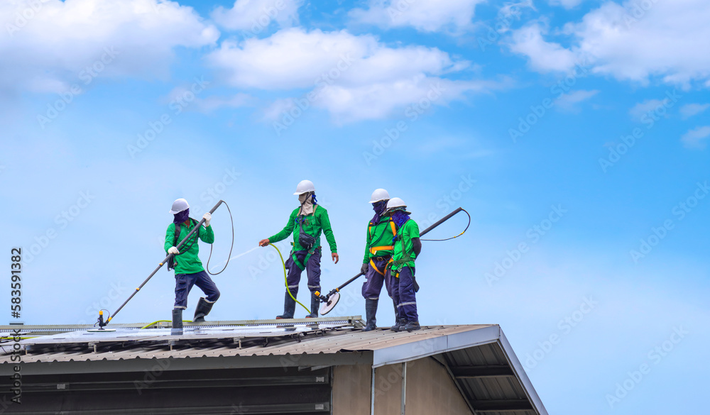 Uniformed crew cleaning solar panels on a flat commercial roof
